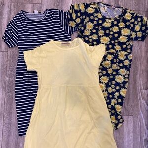 Three dresses - yellow, blue and white striped, navy and yellow flowers.